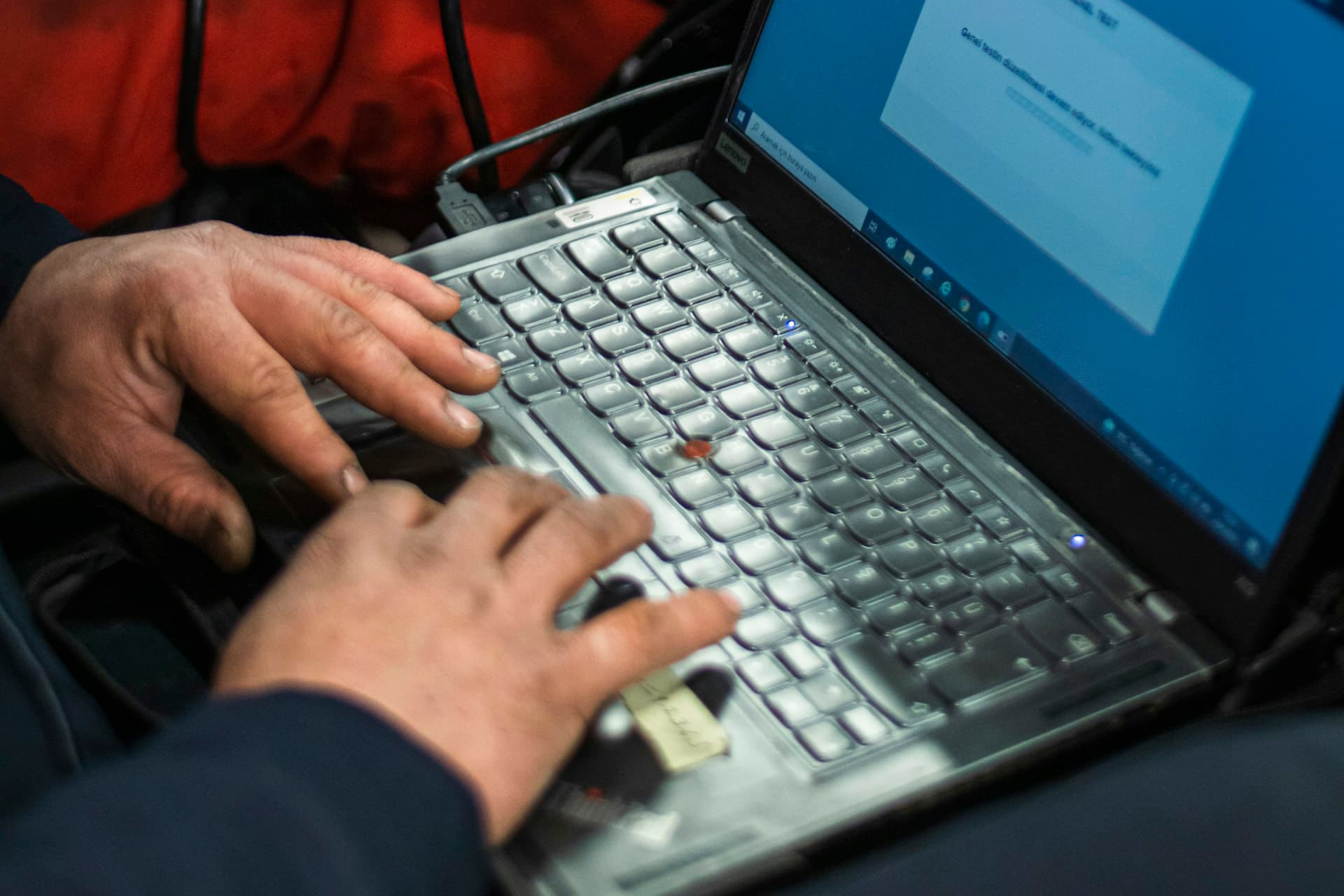 Technician running diagnostic software on a laptop