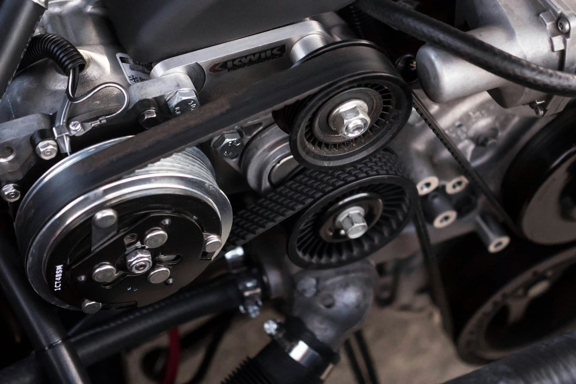 Accessory belt drive and pulleys on the front of an engine